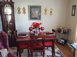 A living room filled with furniture and a red rug

Description generated with very high confidence